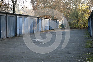 View of a path with many old garages next to each other with metal doors