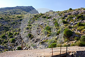 View of Path with Old Railing and Mountains in Background at the Pointview in the City of Cala Sant Vicent, Mallorca, Spain 2018