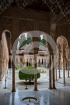 View at the Patio at the Lions, twelve marble lions fountain on Palace of the Lions or Harem, Alhambra citadel, tourist people photo