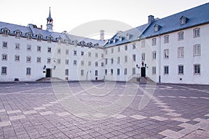 View of patrimonial buildings in the Old Seminary of Quebec courtyard, with the latin inscription meaning Days Flee Like Shadows o