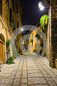 View of a paved alley of Spello in the night, Umbria, Italy