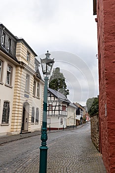 View at paved narrow road with historic buildings and street lamp in Bad Muenstereifel