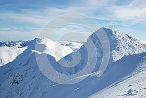 View of the peak of the snow-covered Chopok mountain and the Low Tatras mountain range in the ski resort Jasna, Slovakia