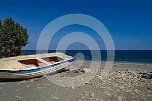 View of the pebble beach of Maleme with a boat