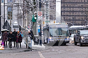 View of Pedestrian crossing on West Georgia Street during the snow fall. Snow storm and extreme weather.