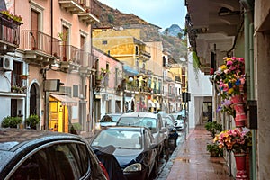 View of pedestrian street and road at Giardini Naxos town in rainy weather. Taormina, Sicily, Italy