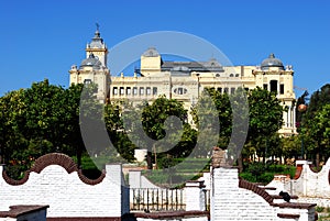 View of the Pedro Luis Alonso gardens with the city hall to the rear, Malaga, Spain.