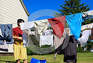 View of people hanging laundry on clothesline in backyard