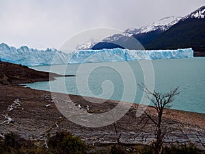 View of the Perito Moreno glacier in Argentina on a cloudy day, mountains in the background