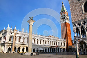 View of Piazzetta San Marco with St Mark`s Campanile, Lion of Venice statue, Biblioteca and Palazzo Ducale in Venice, Italy photo