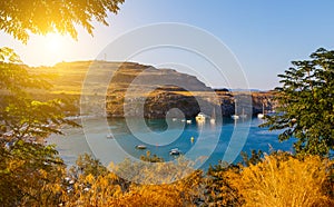 View of picturesque Bay of Lindos with boats and yachts, the famous lagoon among the rocks, sunset, sunlight, Rhodes Greece