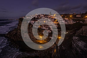 View of the Picturesque village Azenhas do Mar, on the edge of a cliff with a beach below