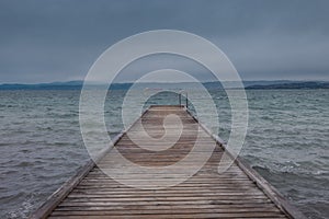 View of a pier in Izola below Bellevedere viewpoint on the north of Adriatic coast. Cloudy weather and long pier. Izola in the