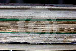 View on  pile of antique yellowed books with edges of cover and textblock