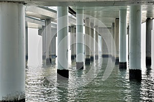 View of piles and water under bridge platform
