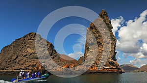 The view of pinnacle rock and a zodiac at isla bartolome in the galapagos