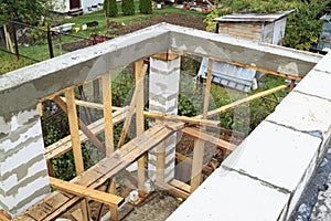 view of pit dug under foundation for a barbecue in annex to house. Site on which the walls are built of gas concrete blocks with