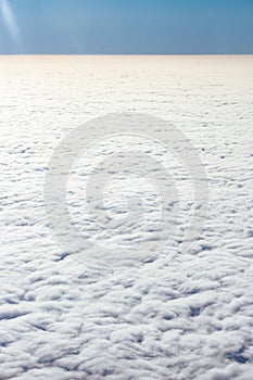 View from the plane from above on the veil of clouds