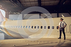 View of plane with captain in the aviation hangar