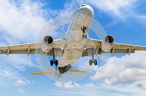 View of a plane landing at the airport under the clouds of blue sky