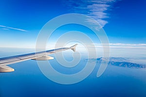 View from plane window at endless blue of aegean sea