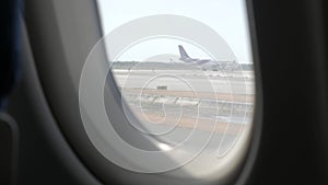 View through plane window while taxing i