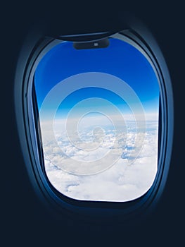 View from the plane window to the clouds and sky during the flight