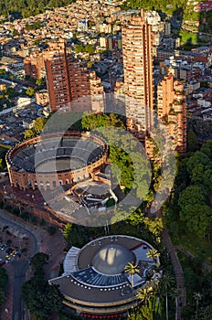 A view of the planetarium and the bullring of Bogota from the top of the Colpatria building, with tall apartment buildings behind photo