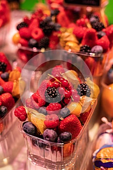 Close up of a plastic container filled with berries in the Boqueria market