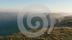 View of plateau Bermamyth among dense clouds during early windy summer morning.