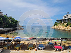 View of Playa Angosta in the traditional part of Acapulco with some palapas