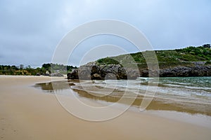 View on Playa de Borizo in Celorio, Green coast of Asturias, North Spain with sandy beaches, cliffs, hidden caves, green fields photo