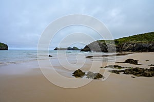 View on Playa de Borizo in Celorio, Green coast of Asturias, North Spain with sandy beaches, cliffs, hidden caves, green fields photo