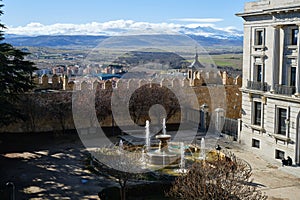 View of the Plaza Adolfo Suarez with a fountain and Snow-capped Sierra de Gredos Regional Park, Avila, Spain photo