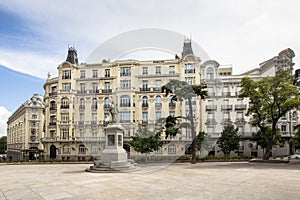 Plaza de las Cortes with statue of Miguel de Cervantes and to the building Plus Ultra Seguros, Madrid, Spain photo