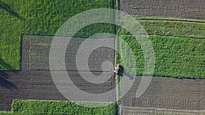 View of a plowed field with a tractor on a sunny day. 4K video, 240fps, 2160p.