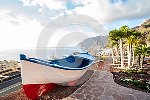 View point of colourful fishing boat near the ocean coast in Los Gigantes, Tenerife, Canary Islands. Summer vibes. Tourism. Travel