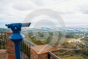 View point in the park of Mijas, a blue coin telescope and a beautiful panoramic aerial view to Mediterranean sea and a road to F