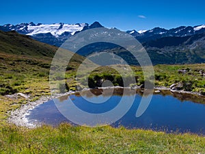 View of a pond in the mountain background in Aoste, Italy