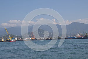 view of the port of Batumi with and cloudy mountains on the coast of the Black sea in a sunny day