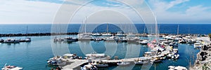 View on port of Vlichada town full with small fishing boats at Santorini island