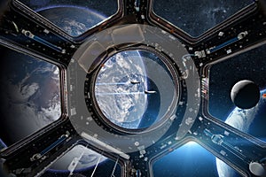 View from a porthole of space station on the Earth background.