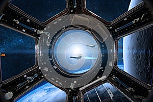 View from a porthole of space station on the Earth background. E