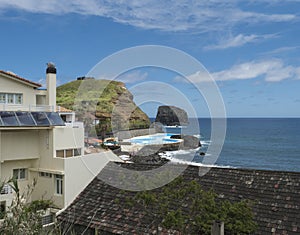 View of Porto da Cruz village with black stone beach and sea water swimming pool. Madeira Island, Portugal