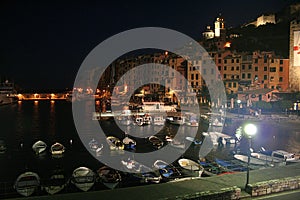 View of Portovenere`s buildings at night and the port with moored boats