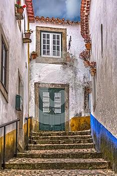 View of a Portuguese vernacular buildings on medieval village inside the fortress and Luso Roman castle of Ã“bidos, in Portugal