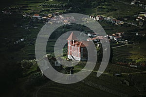 View of a Portuguese village with vineyards in the hills of the Douro Valley.