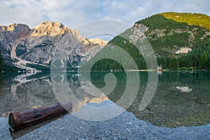 View on Pragser Wildsee with wooden trunk in the water