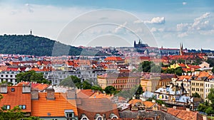 View of Prague Castle over red roof from Vysehrad area at sunset lights, Prague, Czech Republic. Scenic view of Prague city,