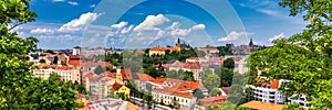 View of Prague Castle over red roof from Vysehrad area at sunset lights, Prague, Czech Republic. Scenic view of Prague city,